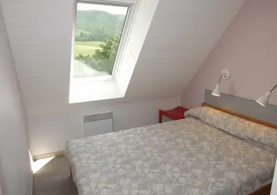 Un ou plusieurs lits dans un hébergement de l'établissement Gite 9 Gîte Puy Mary Séjour Relaxant au Cœur du Parc Naturel Régional